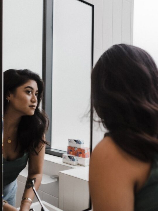 woman looking in mirror