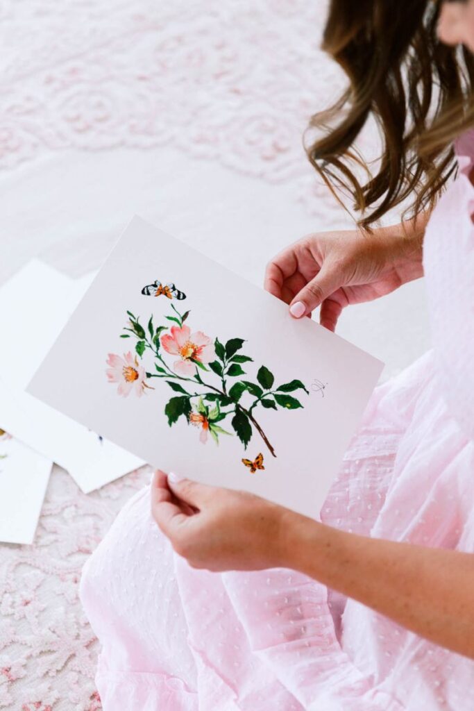 woman looking at what she painted
