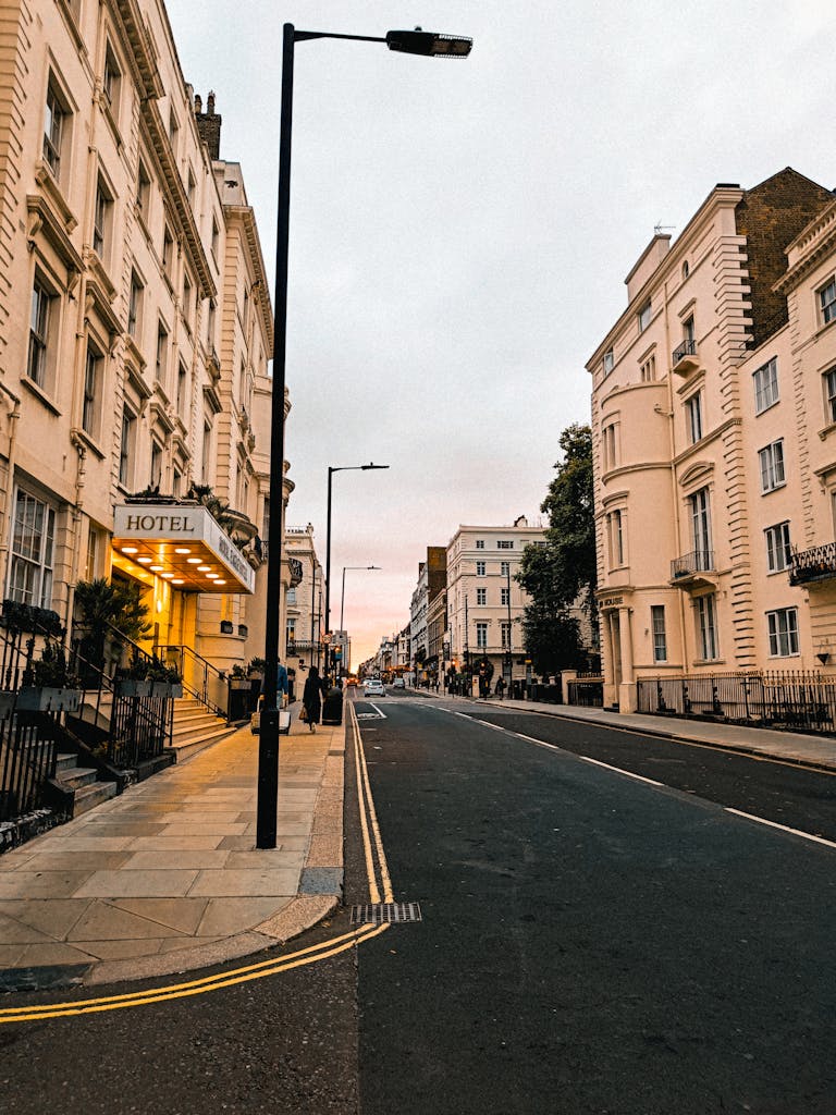 A peaceful street scene featuring historic buildings and a hotel entrance under soft evening light.