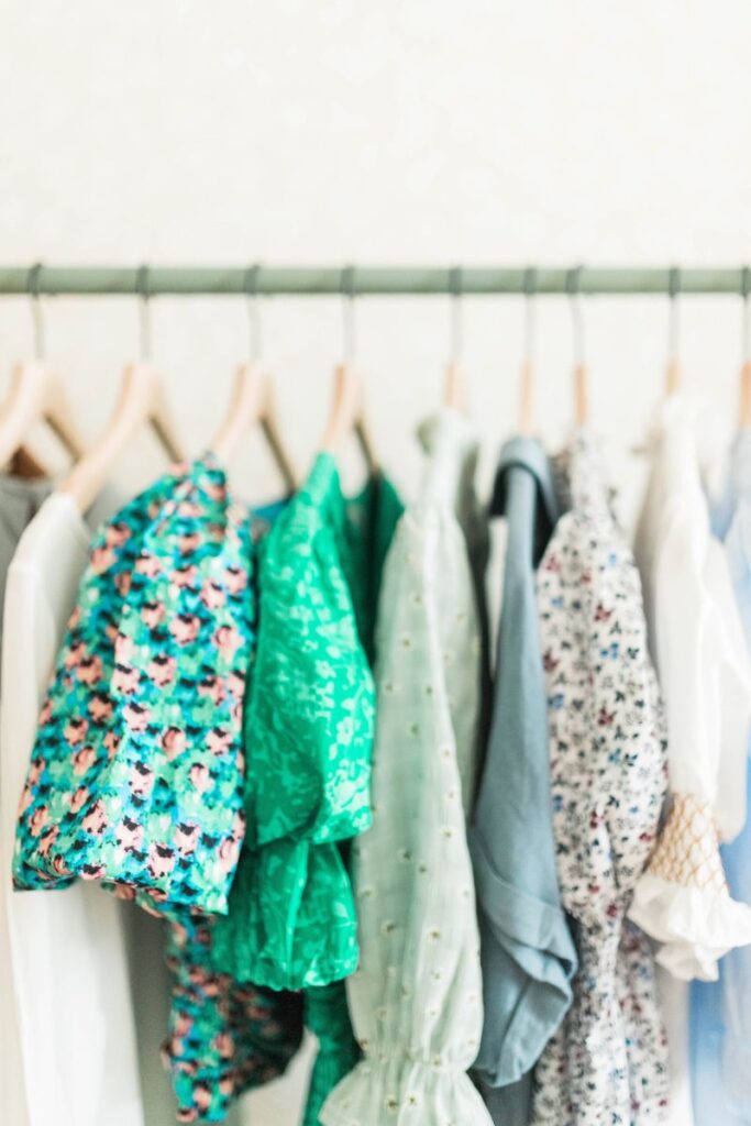 clothes hanging on a rail side profile, mainly greeen
