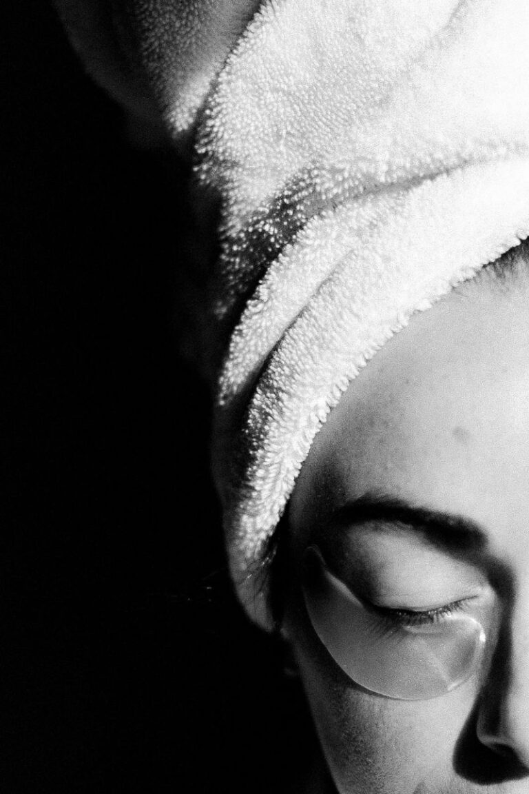 woman giving self home spa face treatment